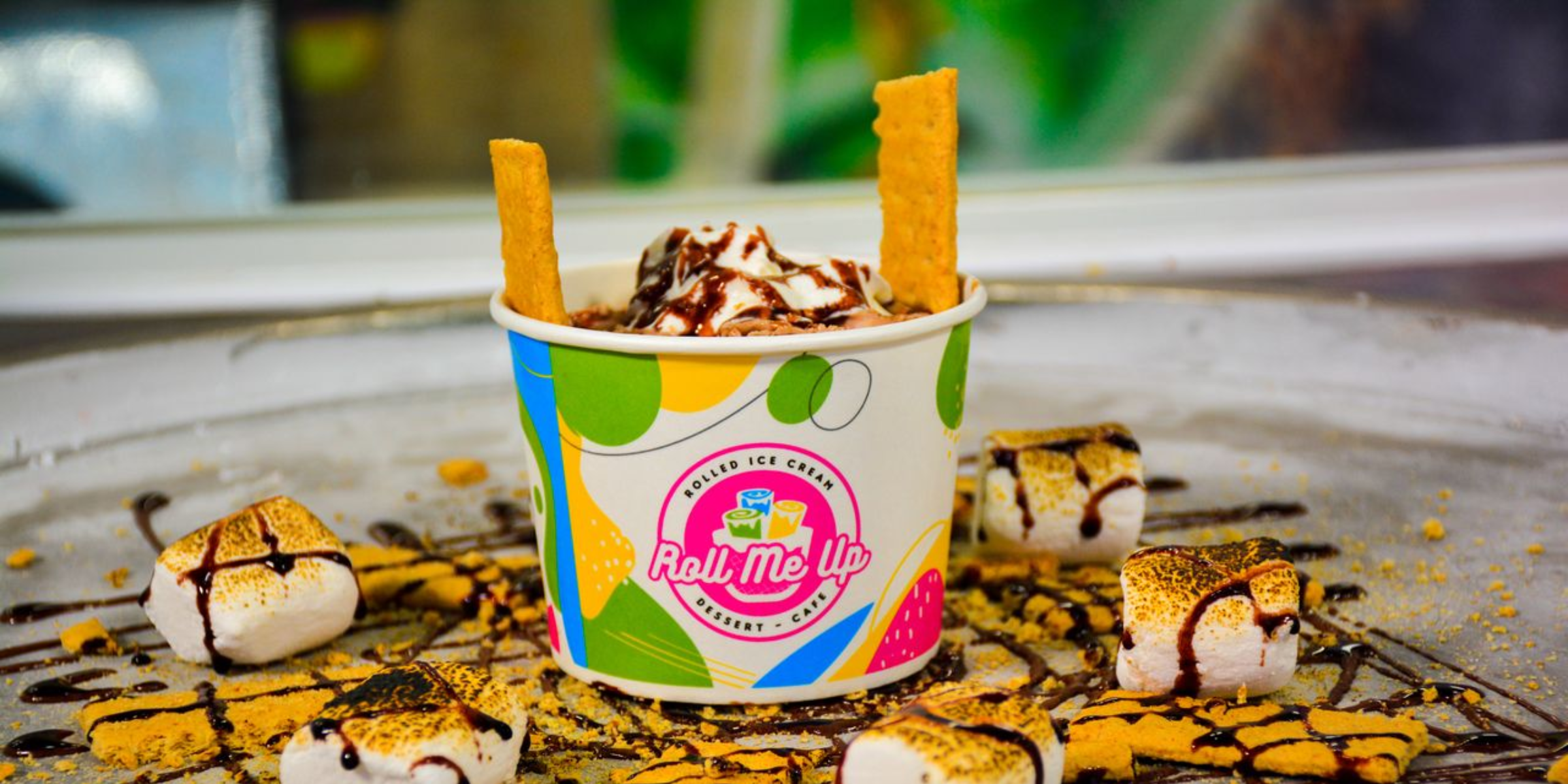 Fresh rolled ice cream being made on a cold plate